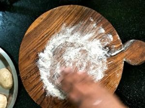 spread wheat flour on rolling board